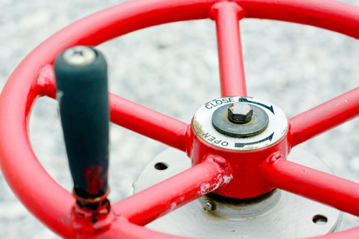 Red industrial wheel valve with handle