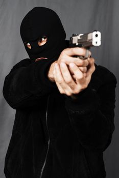 black dressed man and gun in studio