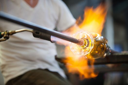 Blowtorch flames surrounding fine art glass object