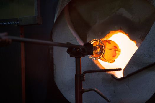 Close view of hot glass object in blast furnace