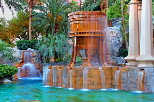 Las Vegas, USA - May 23, 2012: The Mandalay Bay Resort and Casino opened in 1999 in Las Vegas, Nevada.  Seen here is a fountain and pool near the entrance to the resort.