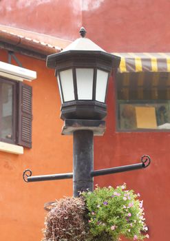 ancient street lamppost with one lamp black