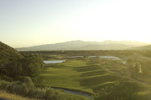 golf course view from above with bright sunlight from side