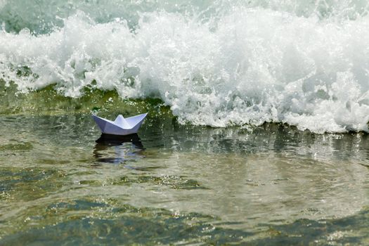 Right now, origami paper boat disappear, absorbed by the sea foamy waves
