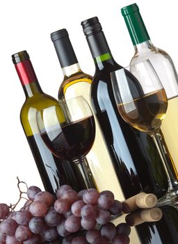 Several bottles of white and red wine, two glasses and grapes isolated on white background