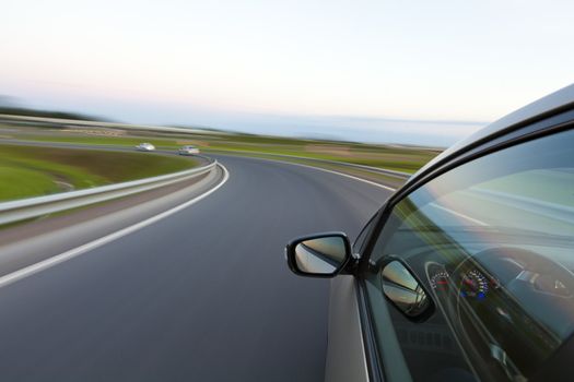 Car goes very fast to turn a country road at night