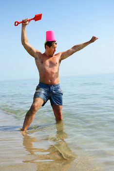 madman is playing the role of a warrior with beach toys