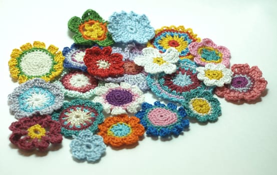 A lot of bright colorful knitted flowers