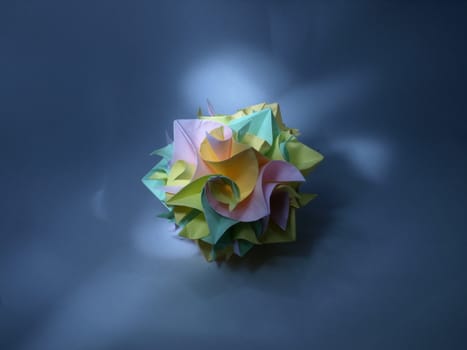 Origami ball from colorful papers, still life