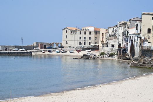 beach of Cefalu with centre city in the background. Sicily