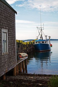 A lobster boat at dock with traps ready for the next sason