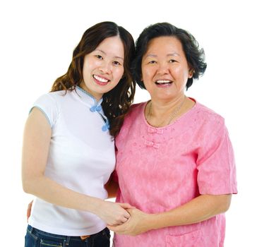 Asian senior mother and daughter holding hands over white background