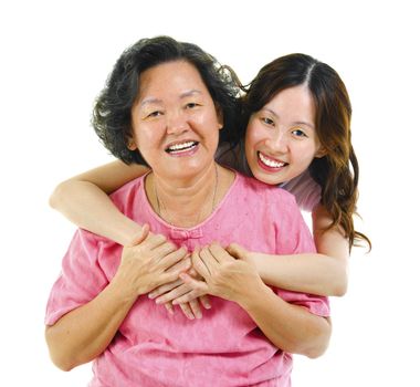 Happy Asian senior mother and adult daughter over white background