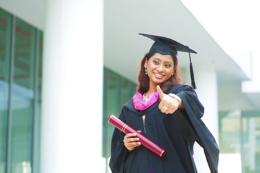 Indian female graduate giving a thumb up