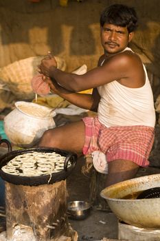 Indian street vendor preparing sweets for sale at the Sonepur livestock fair, India