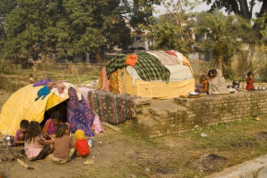 Poor Indian families living in makeshift shacks by the side of the road in Bihar, India.
