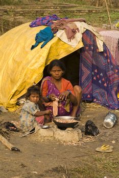 Poor Indian family living in a makeshift shack by the side of the road in Bihar, India.