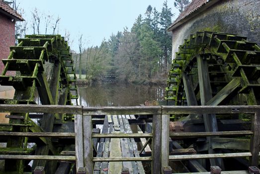old waterwheel for generating green energy from water falling