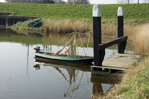 small empty green boat on the river in the water