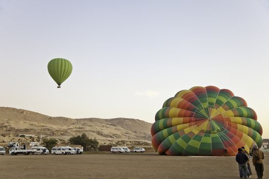 hot air balloon infront of valley of the king, luxor, egypt