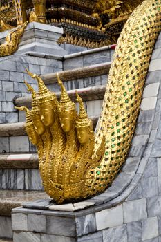 angel head golden naga statue in emerald buddha temple, bangkok, thailand