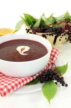 a bowl with Elderberry soup of fresh elderberries