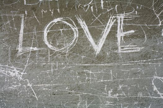 Word 'Love' Scratched on a wall