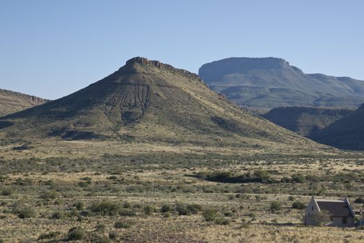 Karoo National Park in the Western Cape of South Africa. Arid landscape with flat topped hills. Visitor accommodation.