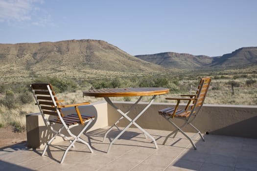 Rest camp in Karoo National Park in the Western Cape of South Africa. Table and chair on the veranda of a chalet.