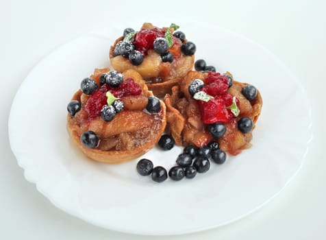 Sweet dessert with apples blueberries and cranberries