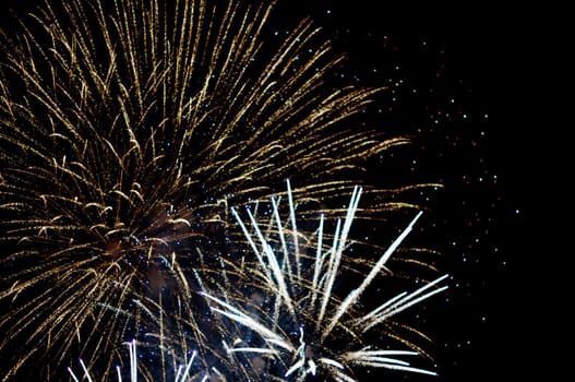 A delicate burst of fireworks in the night sky with room for your copy text (happy new year)