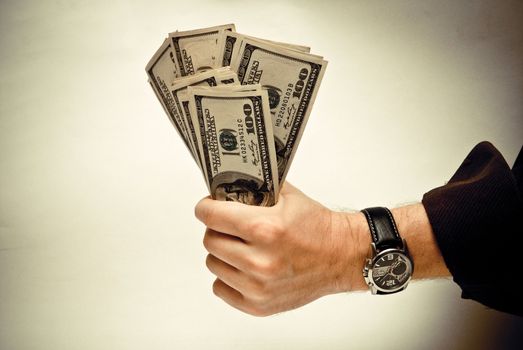 The pile of US federal reserve notes $100 in a man's hand. Old style photo.