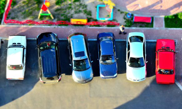 Six bright toy cars, parking side by side