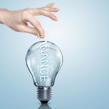 Hand putting a busines term into a light bulb