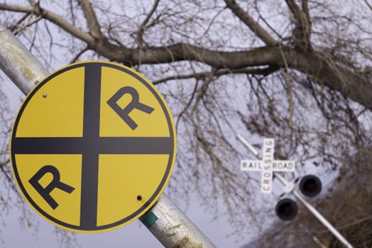 bright railroad crossing sign at an angle