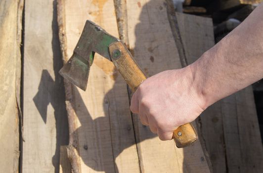 Man's hand with hatchet