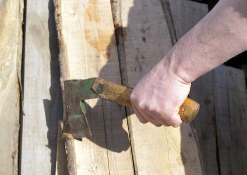 Man's hand with hatchet