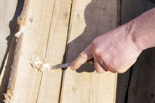 Man's hand with chisel