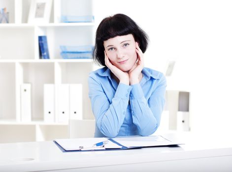 Portrait of a business woman in the office doing some paperwork