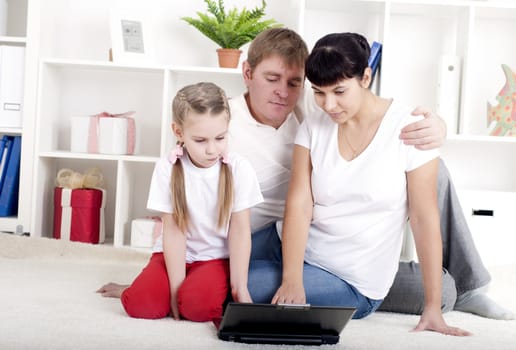 family are working together for a laptop at home