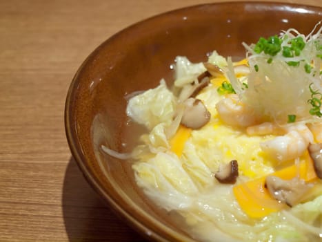 Omelette rice(omurice or oromuraisu) in japanese soup with shiitake mushroom, shrimp and vegetable, japanese food