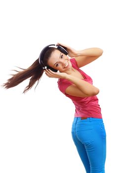 Happy smiling girl dancing and listening to music