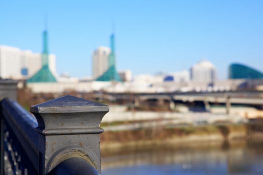 Close up of Old Steel Railing on Portland Bridge with Portland Convention Center in soft focus background