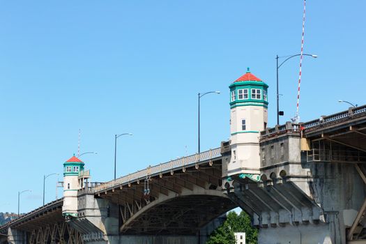 Close up image of Burnside Bridge in Portland, Oregon with cloudless blue sky