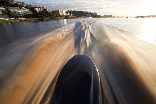 Water in the back of high speed boat