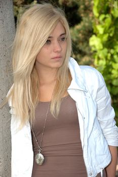 Young female model wears casual clothes. Sits with natural face expression, teenage girl cool and relaxed. 