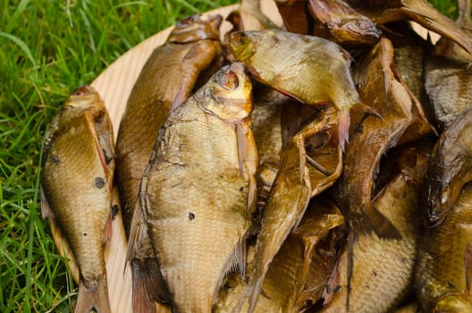 Freshly smoked healthy ecologic fish from smokehouse closeup.