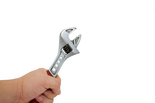 a thumb adjusting a adjustable wrench against white background