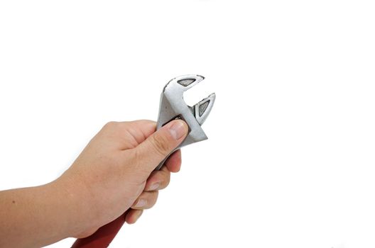 a thumb adjusting a adjustable wrench against white background