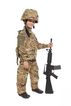 Young boy dressed like a soldier with rifle isolated on white